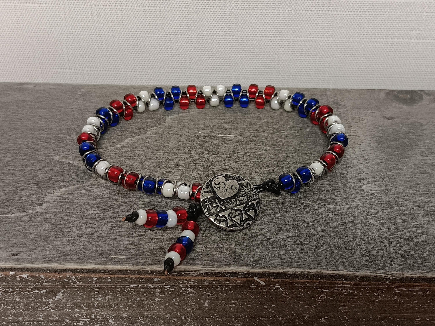 Cast metal shank button beaded bracelet, on leather cord. Glass bracelet, shank button bracelet.