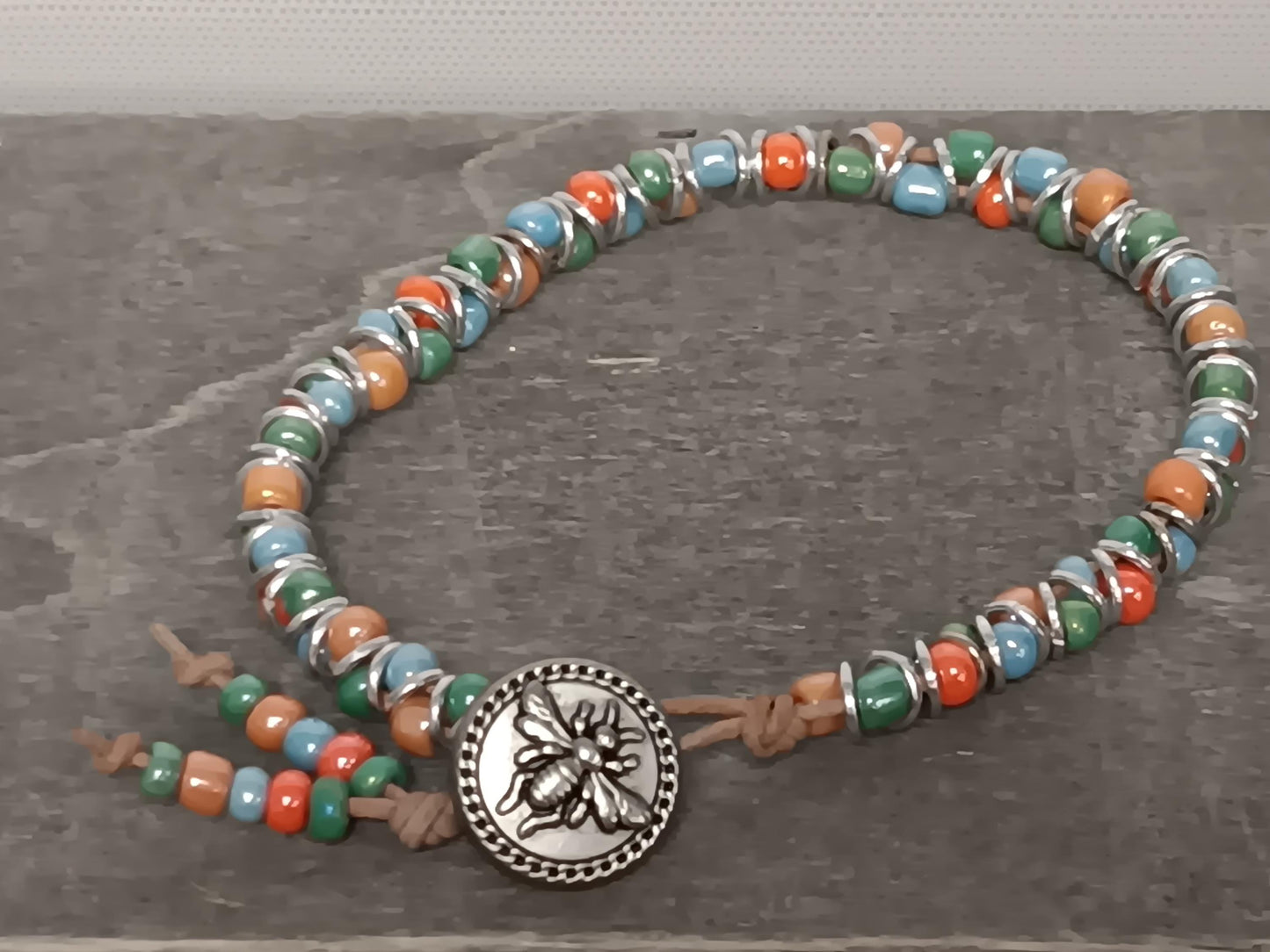 Cast metal shank button beaded bracelet, on leather cord. Glass bracelet, shank button bracelet.