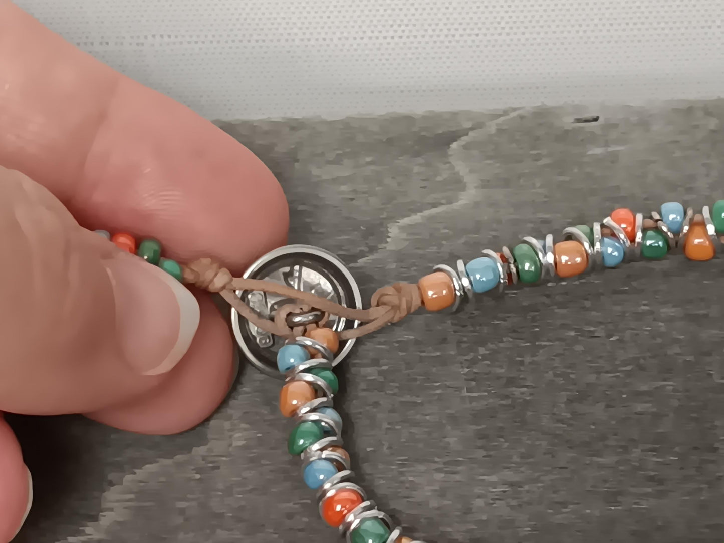 Cast metal shank button beaded bracelet, on leather cord. Glass bracelet, shank button bracelet.