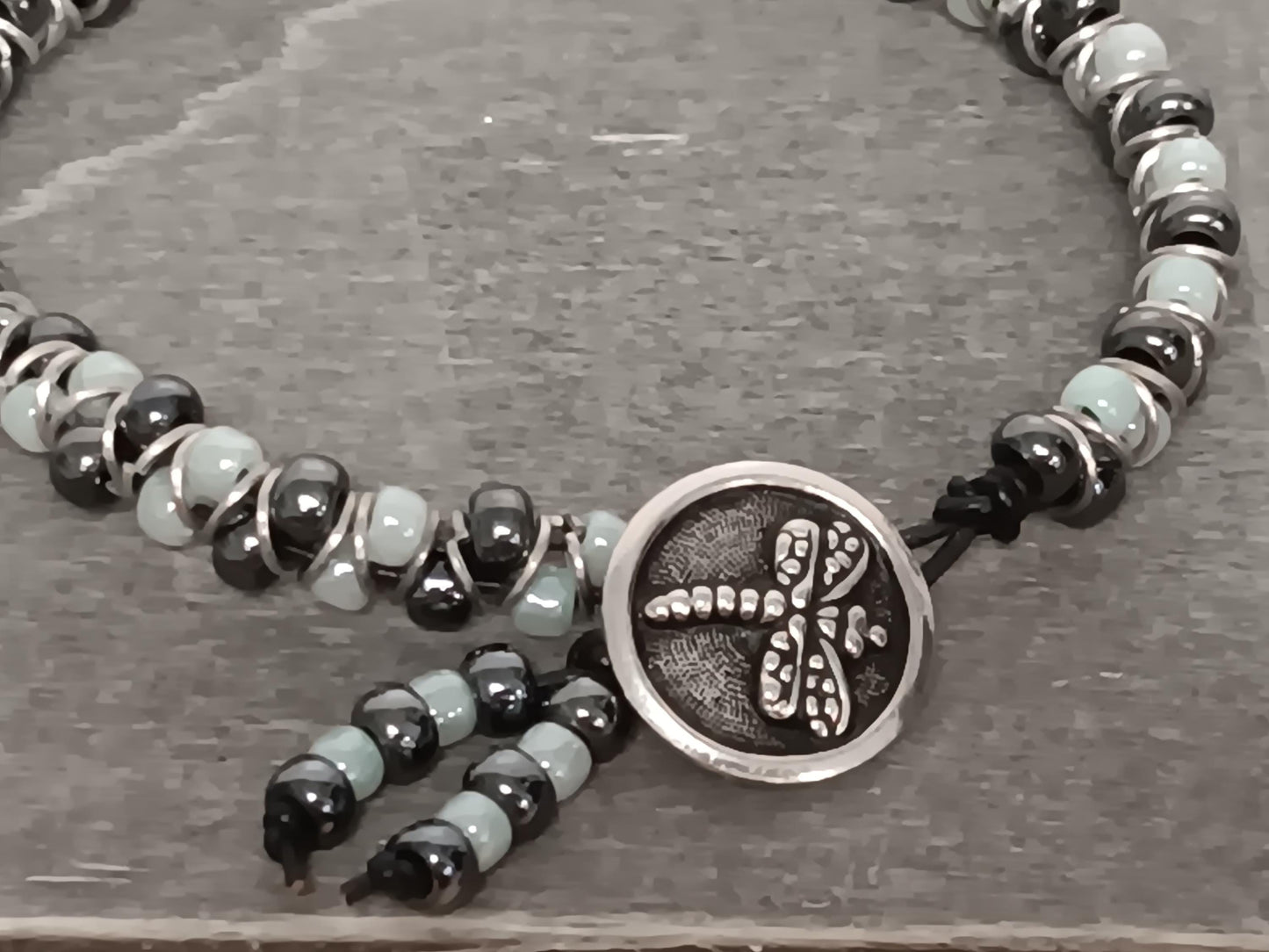 Cast metal shank button beaded bracelet, on leather cord. Glass bracelet, shank button bracelet.