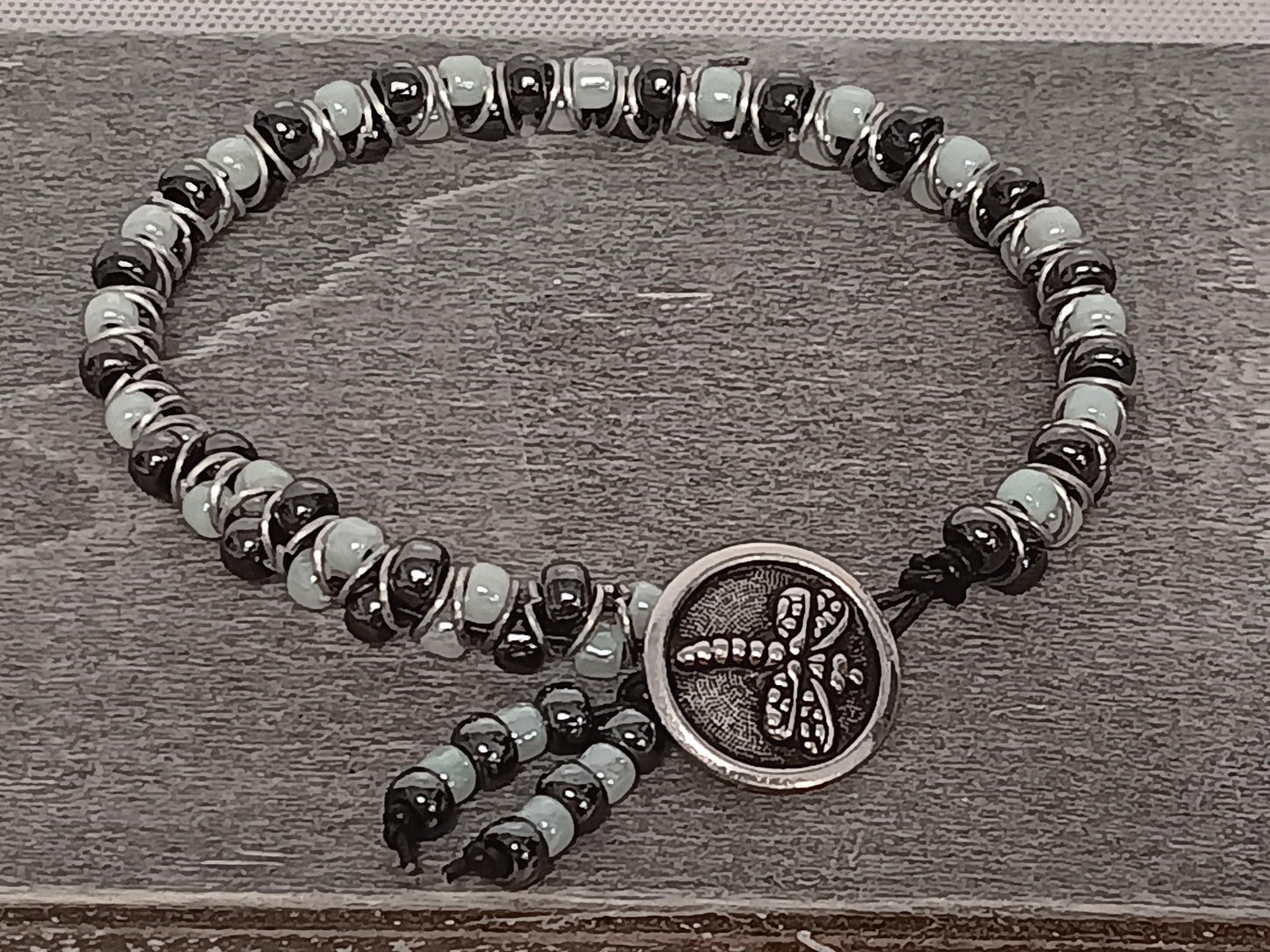 Cast metal shank button beaded bracelet, on leather cord. Glass bracelet, shank button bracelet.