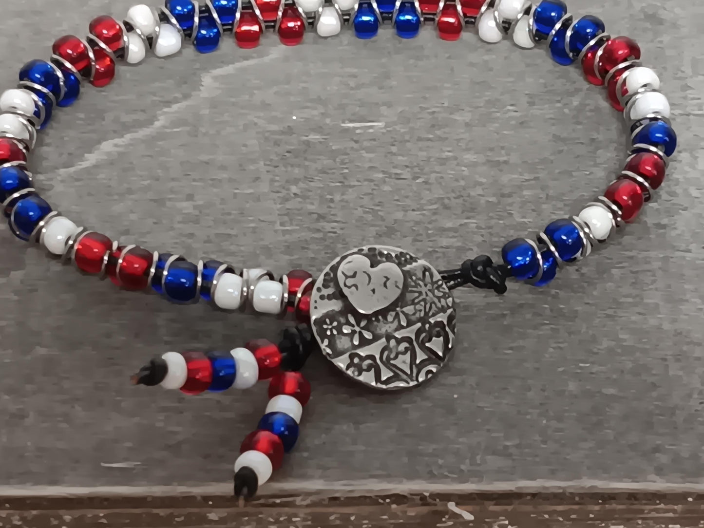 Cast metal shank button beaded bracelet, on leather cord. Glass bracelet, shank button bracelet.